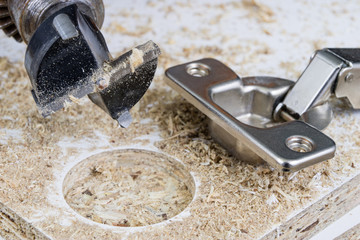 Milling cutter for fixing hinges in chipboard. Joinery accessories for furniture construction.
