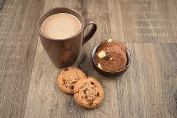 Cookies with milk on a wooden background stock images. Cookies with chocolate milk stock images. Biscuits on a wooden background. Cup of chocolate milk with snack
