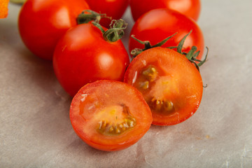 Tomatoes on baking paper, cut in half.
