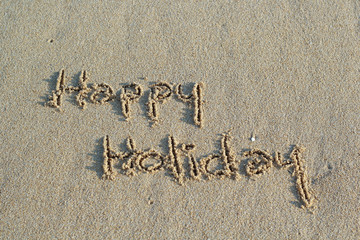 Hello Holidays. written in sand at the beach