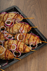 Lulya-kebab. Shish kebab on a stick, minced meat. Traditional Caucasian dish. On a cutting board, with green salad, ketchup, spices