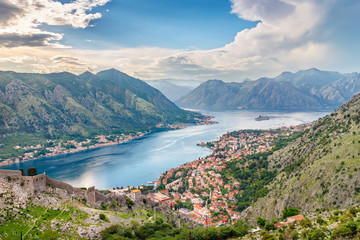Panoramic view from above on the old city Kotor, bay in Adriatic sea and mountains in Montenegro at sunset time, gorgeous nature landscape