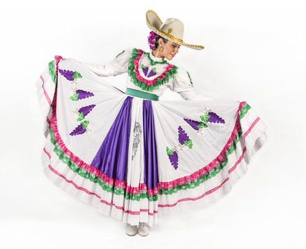 Charming dancer  wearing a picturesque dress used in the state of Aguascalientes in Mexico. 