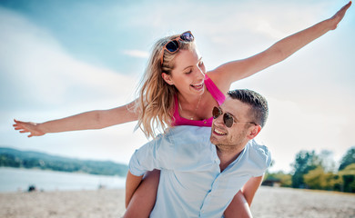 Couple having fun on the beach. Lifestyle, love, dating, vacation concept