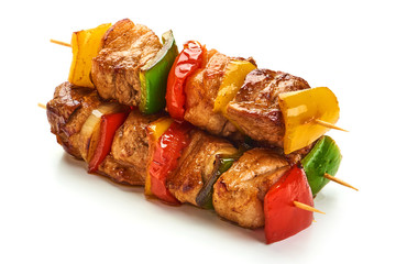 Skewers with pieces of grilled barbecue, red, yellow and green bell pepper, seasoned with coarse...