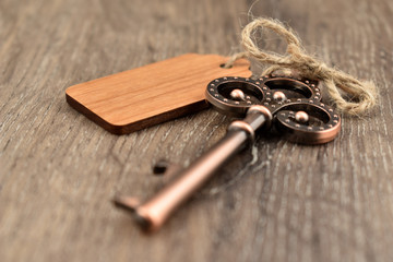 Decorative metal key on a wooden background stock images. Decorated key images. Romantic key with...