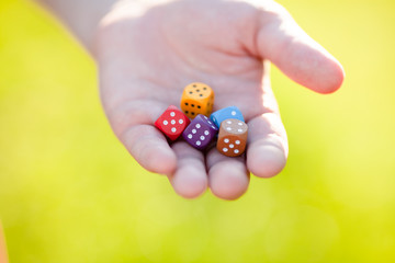 Mixed color dice at adult man hand