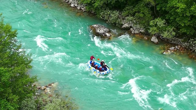 Aerial shot of people in boat whitewater rafting trip on Tara river in Montenegro, slow motion