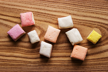 Colorful marshmallow on wooden surface. Top view
