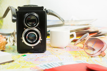Old camera like travel concept with coffee, sunglasses, money and map
