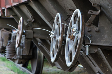 Unloading mechanism of railroad freight car (hopper car), selective focus, closeup