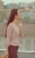 Fototapeta premium Pretty young woman posing near a glass wall