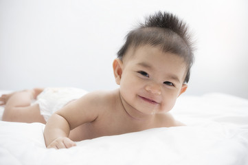 baby girl lying on a bed