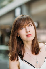 Closeup portrait of positive girl. Close up portrait of beautiful face of young smiling woman