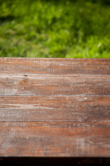 wooden picnic tabletop in the garden - summertime background with copy space
