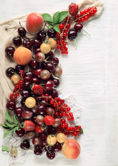 Colorful fruits and berries fresh from the market,
decorated on white wood plate,
free space for your text, can be used as background  - 211187020