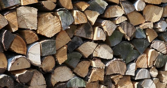 Stacks of firewood. Pile of firewood prepared for fireplace. Firewood background.