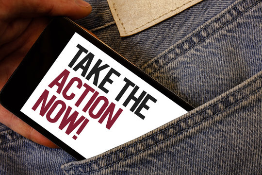 Writing note showing  Take The Action Now Motivational Call. Business photo showcasing Act Start Promptly Immediate Instantly Human hand bring out cell phone with colorful text jeans back pocket.