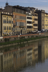 Fototapeta na wymiar Building reflection of Arnoriver in Florence, Italy