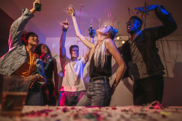 Friends dancing at a house party