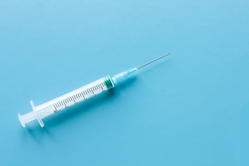  Medicine concept. Medical syringes on blue background, doctor's tool, give an injection and be healthy, vaccination.
