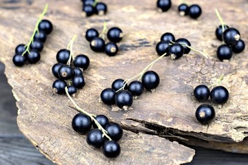 Healthy food,agriculture,harvest and fruit concept: fresh ripe black currants on an old wooden background.