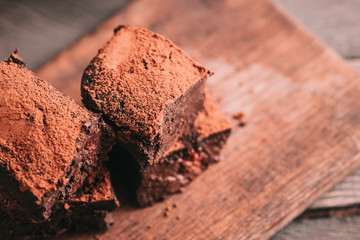 Decadent moist dark chocolate stout beer brownies cut in squares. Dark food photography concept