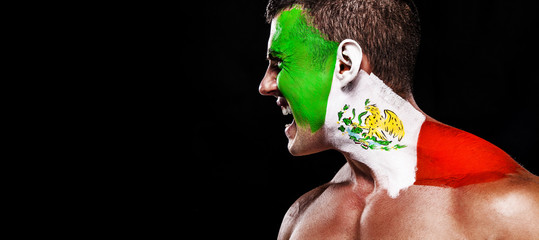 Soccer or football fan with bodyart on face with agression - flag of Spain.