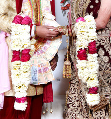 The bride and groom at the Indian wedding garlands or Jaimala ceremony