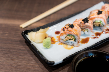 Philadelphia roll sushi with salmon, cucumber, avocado, cream cheese, tobiko caviar. Sushi menu. Japanese food.