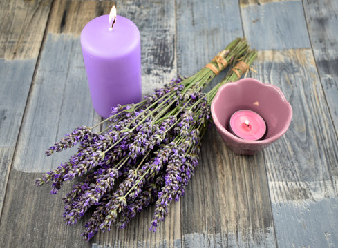 Lavender decoration stock images. Lavender on a wooden background. Bunch of french lavender. Lavender and candles images. Aromatic spa still life