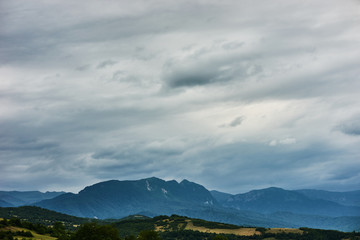 Mountain forest landscape covered by green pine under morning sky with clouds, Country Side