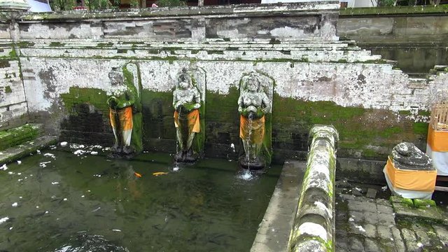 Panning: Buddhas Pouring Water To The Pond In Bali