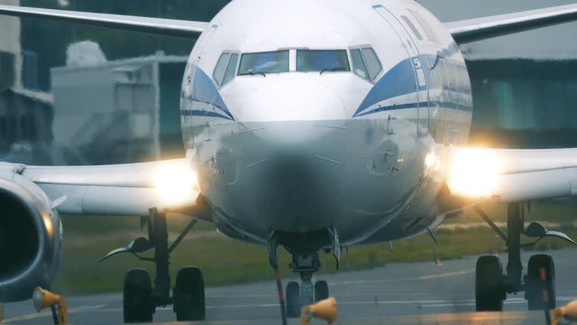 Airplane taxiing on the taxiway after landing. Front view