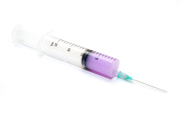 Medical syringe 20ml with liquid, lying on a white background. Equipment for vaccination in medicine for laboratories and hospitals