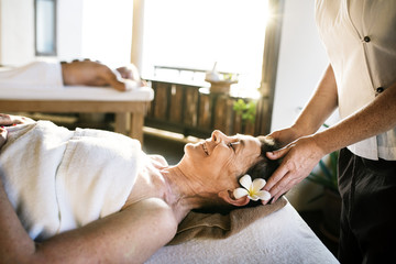 Female message therapist giving a massage at a spa