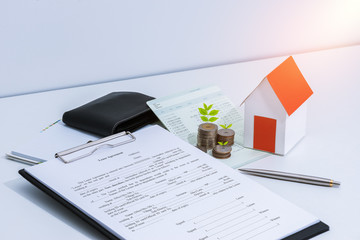 saving account passbook or financial statement, paper house model, and coins with Property Leasing...