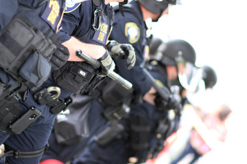 Police officers wearing riot gear.
