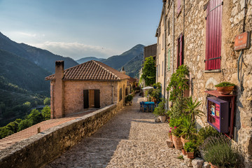 Cafe and laneway in the mountain village of Saint Agnes in the Alps Maritime near Menton, South of...