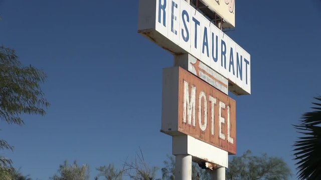 Birds Fly from Old Restaurant and Motel Sign