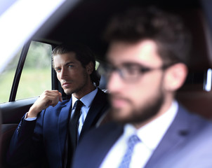 business people sitting in car