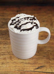 Hot Drink in a Mug with Whipped Cream on a Wooden Table