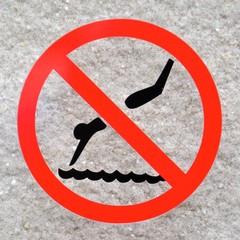No diving sign on a white stone background