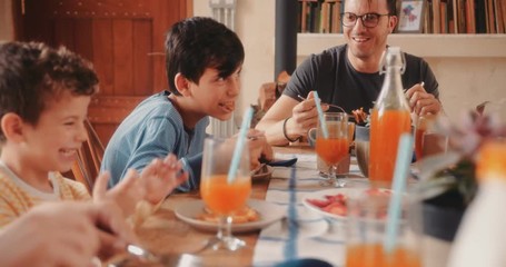 Happy family eating breakfast together in the morning - Powered by Adobe