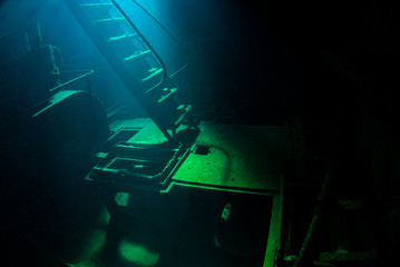 Obraz na płótnie Canvas An underwater shot inside a room in the shipwreck of the Kittiwake that uses natural light as opposed to a strobe. The wreck has been sunk deliberately and is shallow enough to allow light penetration