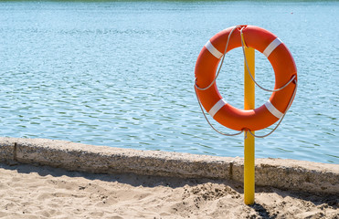 a life preserver on the shore of the lake to rescue drowning