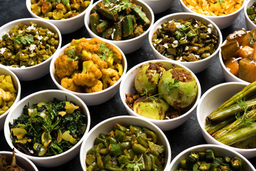 Indian sabzi / vegetable fried recipes served in white bowl over moody or colourful background. selective focus