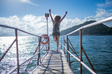 tourist woman jumping on the bridge