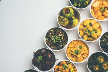 Indian sabzi / vegetable fried recipes served in white bowl over moody or colourful background. selective focus