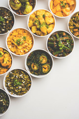 Indian sabzi / vegetable fried recipes served in white bowl over moody or colourful background. selective focus